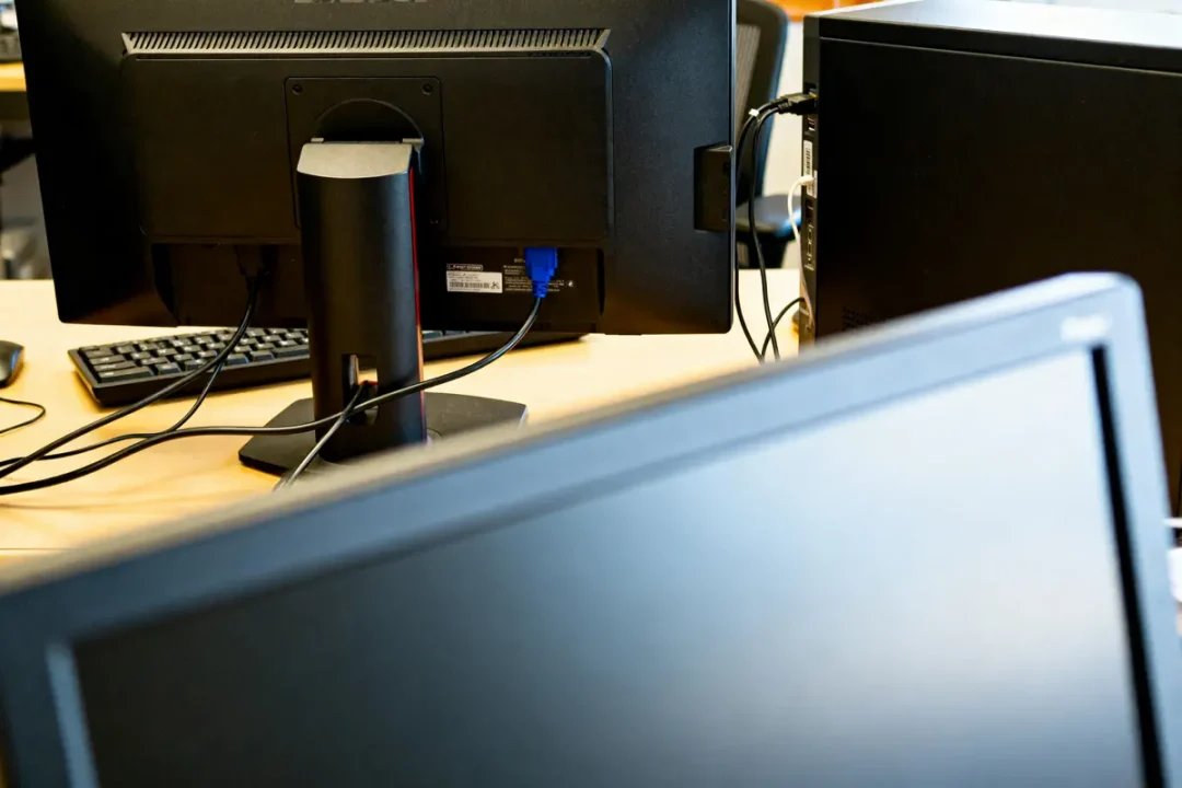 Ordinateur toujours en marche avec écran qui s'éteint sur un bureau de travail